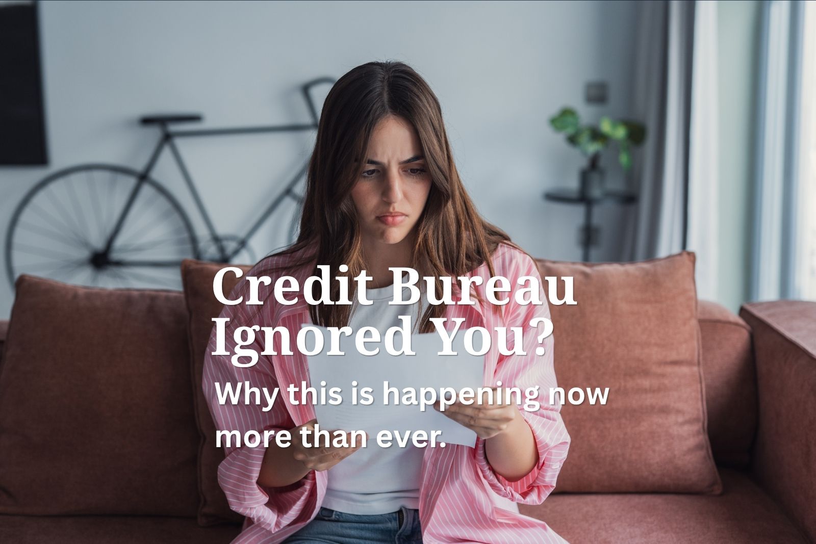 Frustrated consumer reviewing a credit report after a dispute was ignored by a credit bureau.
